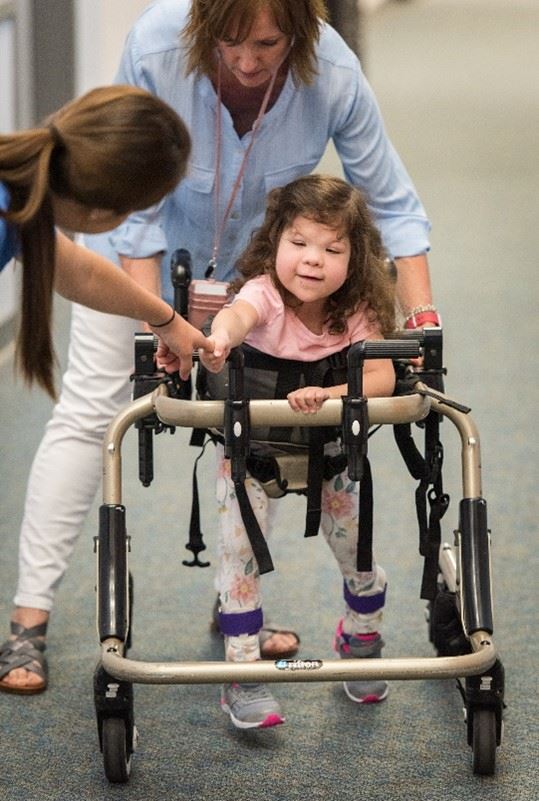 Therapist with student - learning to walk in the hallway Therapist with student - learning to walk in the hallway